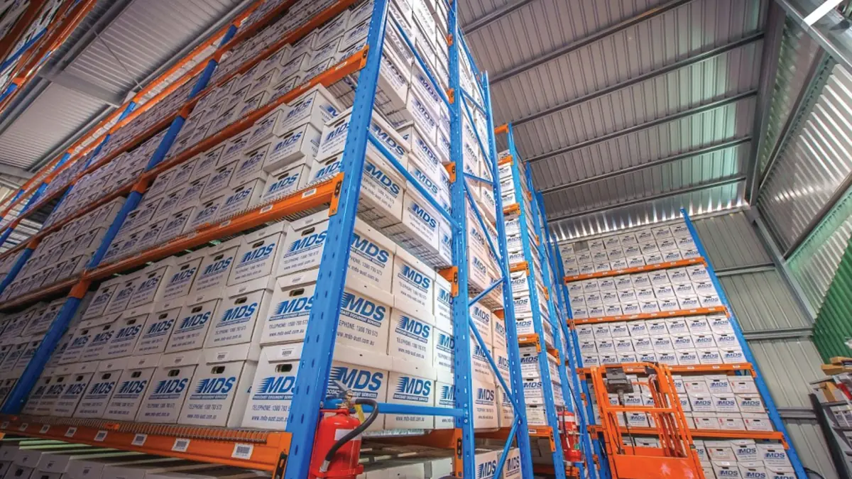 MDS warehouse with archive boxes and blue storage shelves